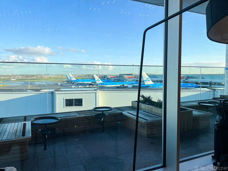 a window with a view of planes in the background
