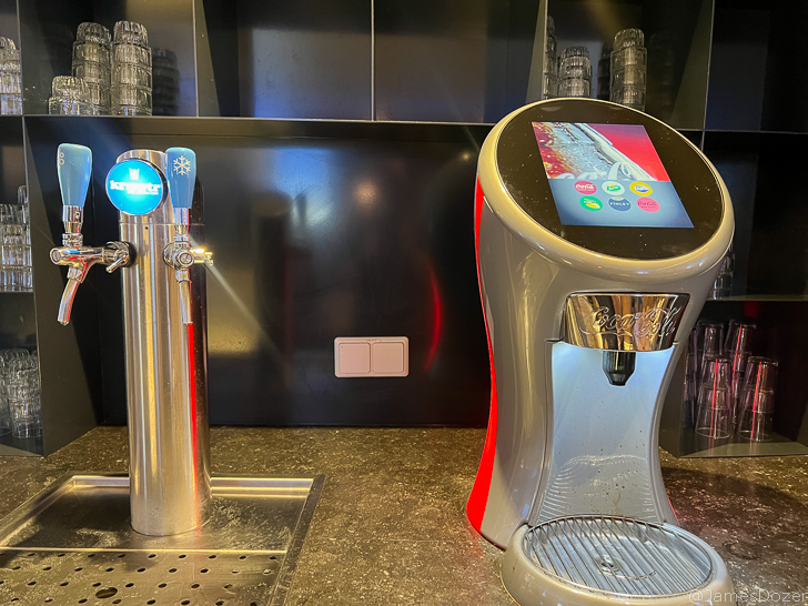 a machine next to a drink dispenser