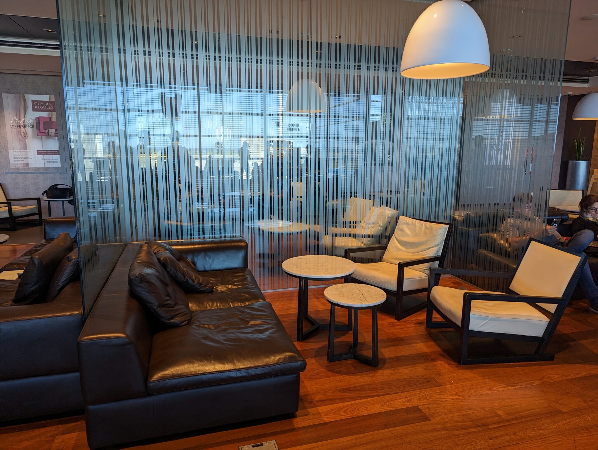 a room with a couch and chairs
