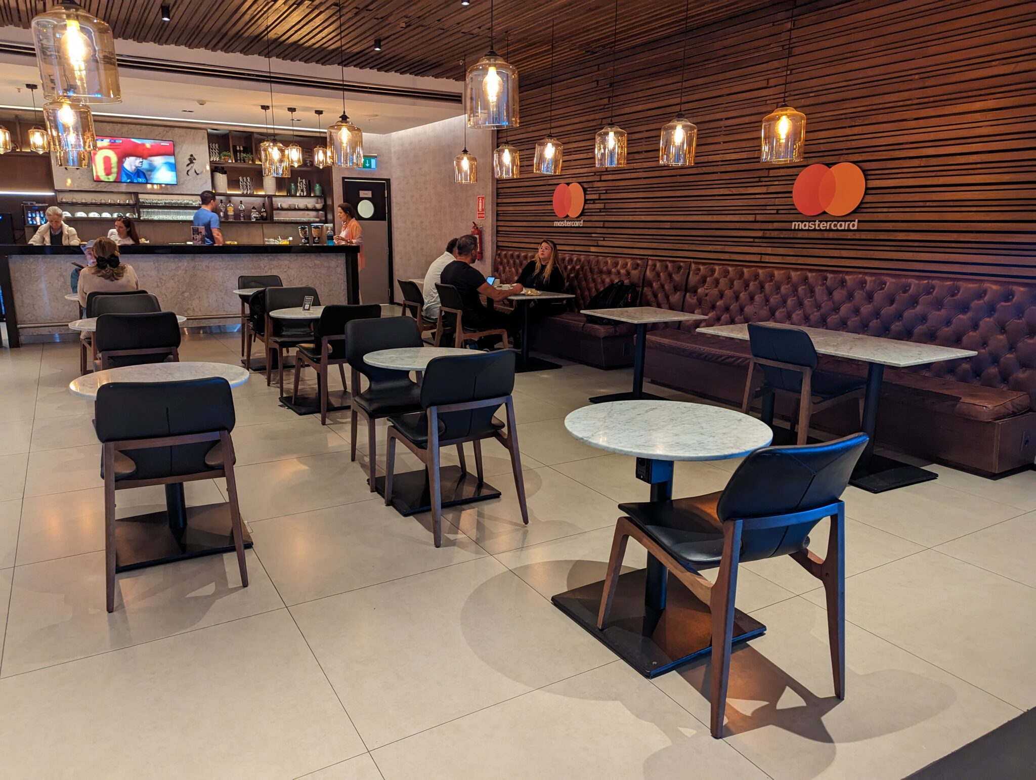 a group of people sitting at tables in a restaurant