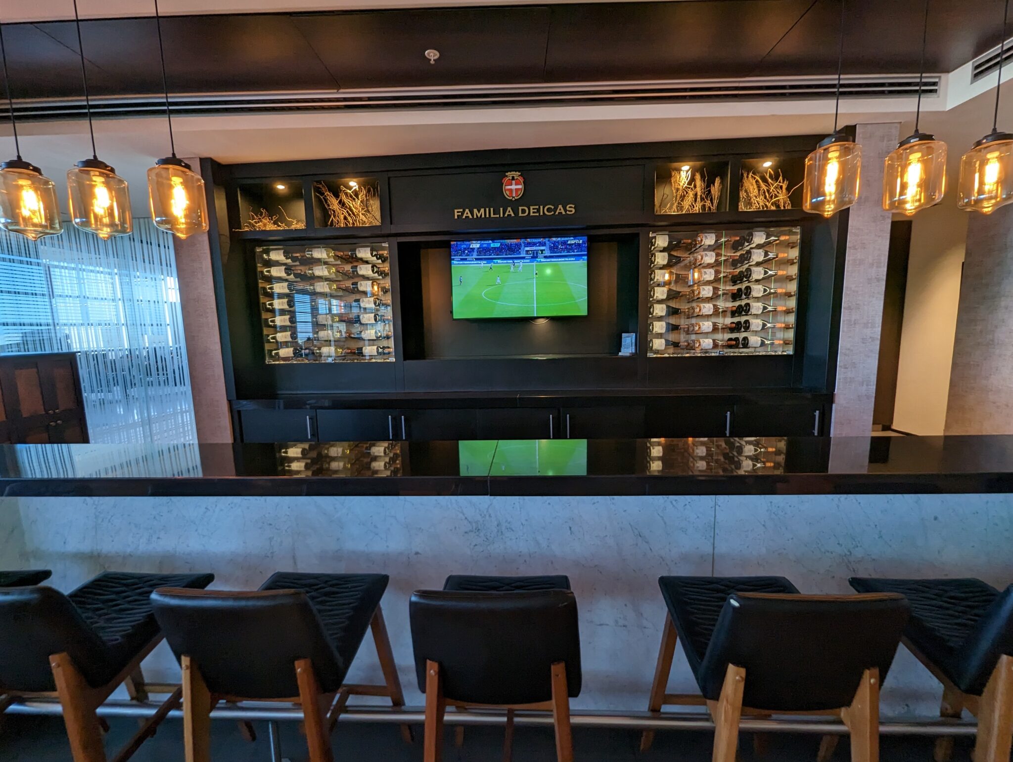 a bar with a television and chairs
