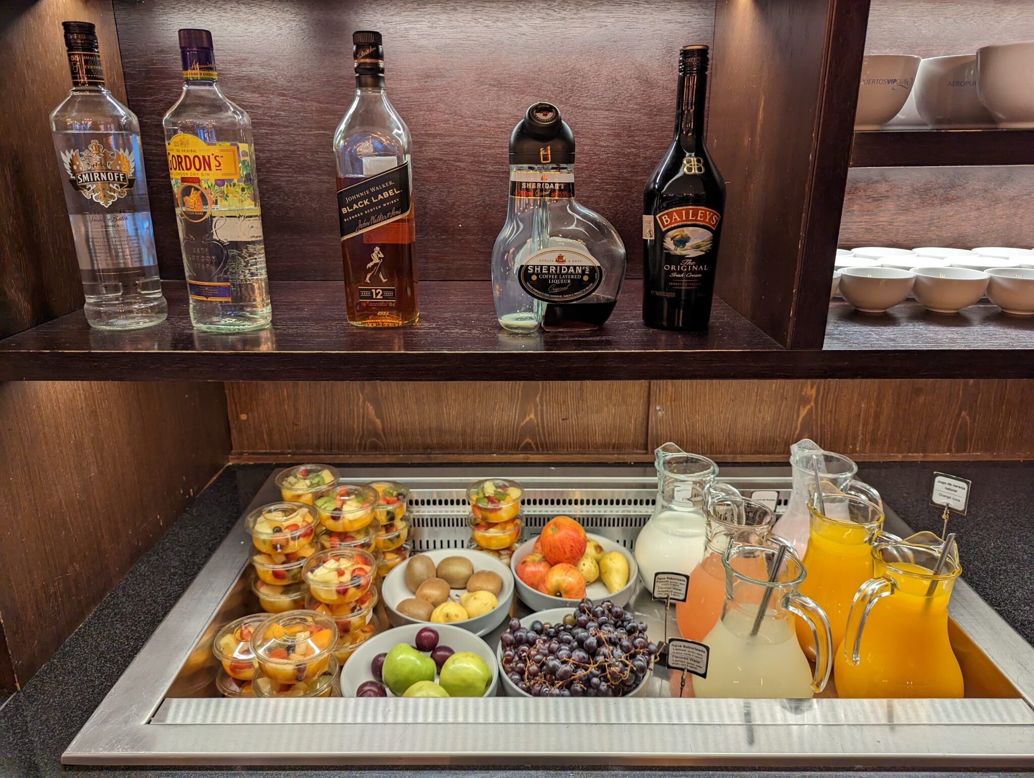 a shelf with bottles of alcohol and fruit