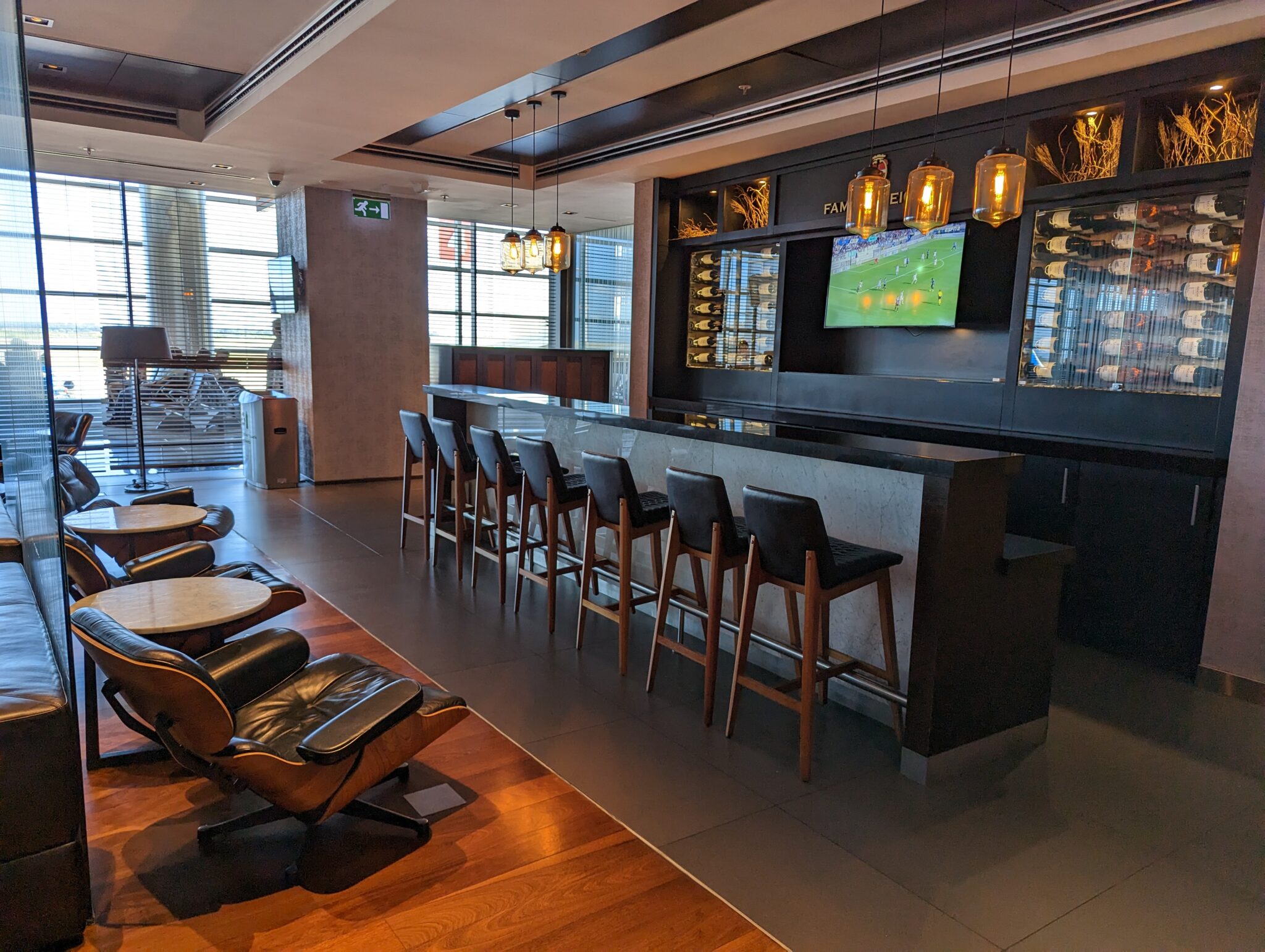 a bar with chairs and a television