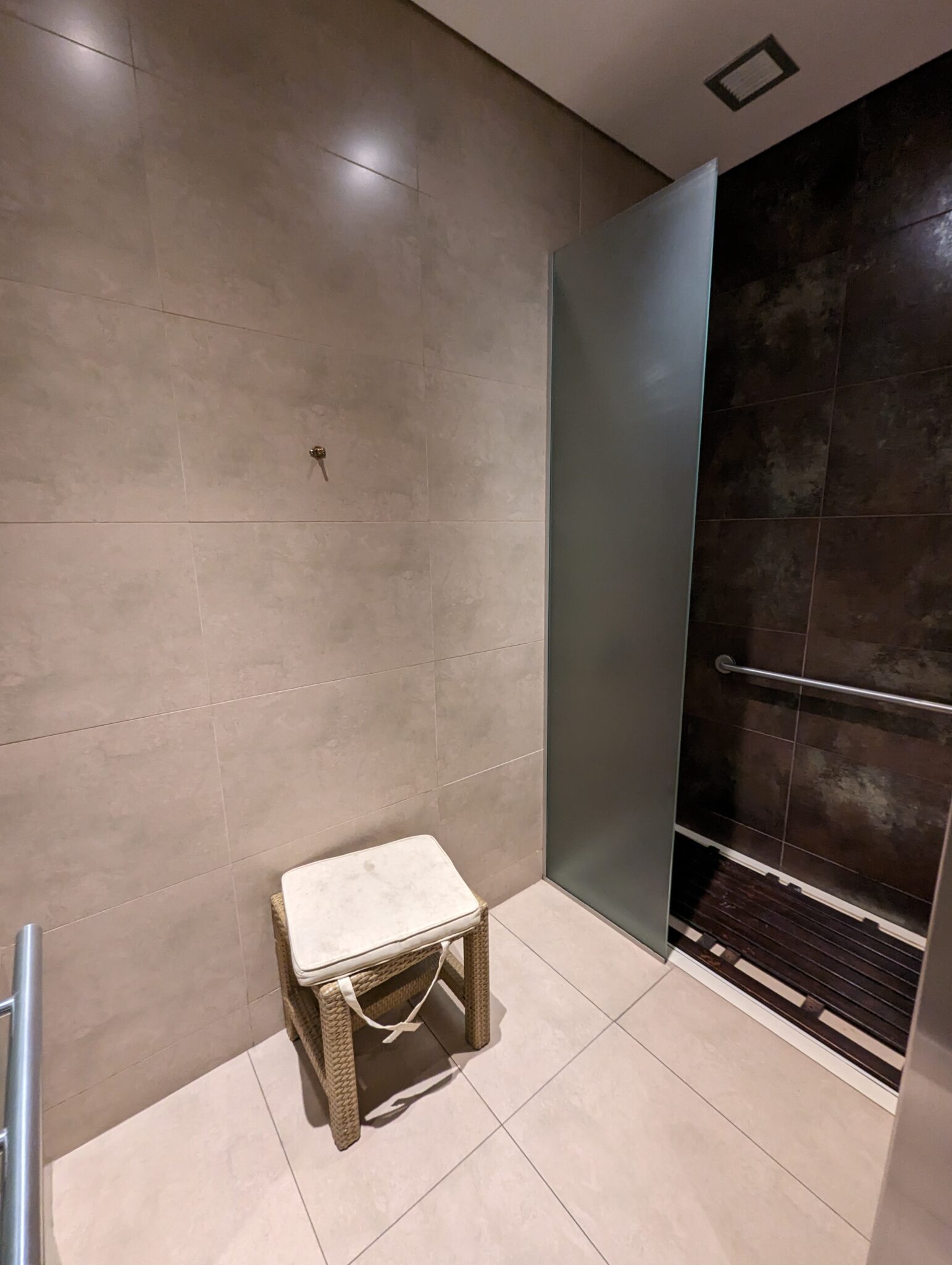 a shower with a stool