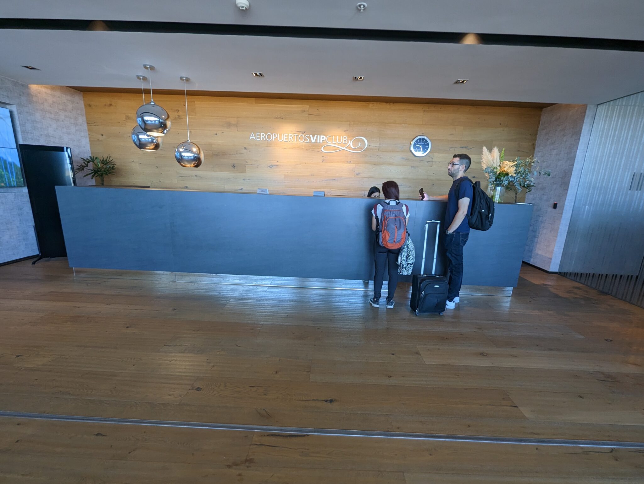 a man and woman standing at a reception desk