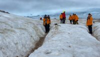 a group of people walking on snow