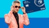 a man holding sunglasses and a credit card