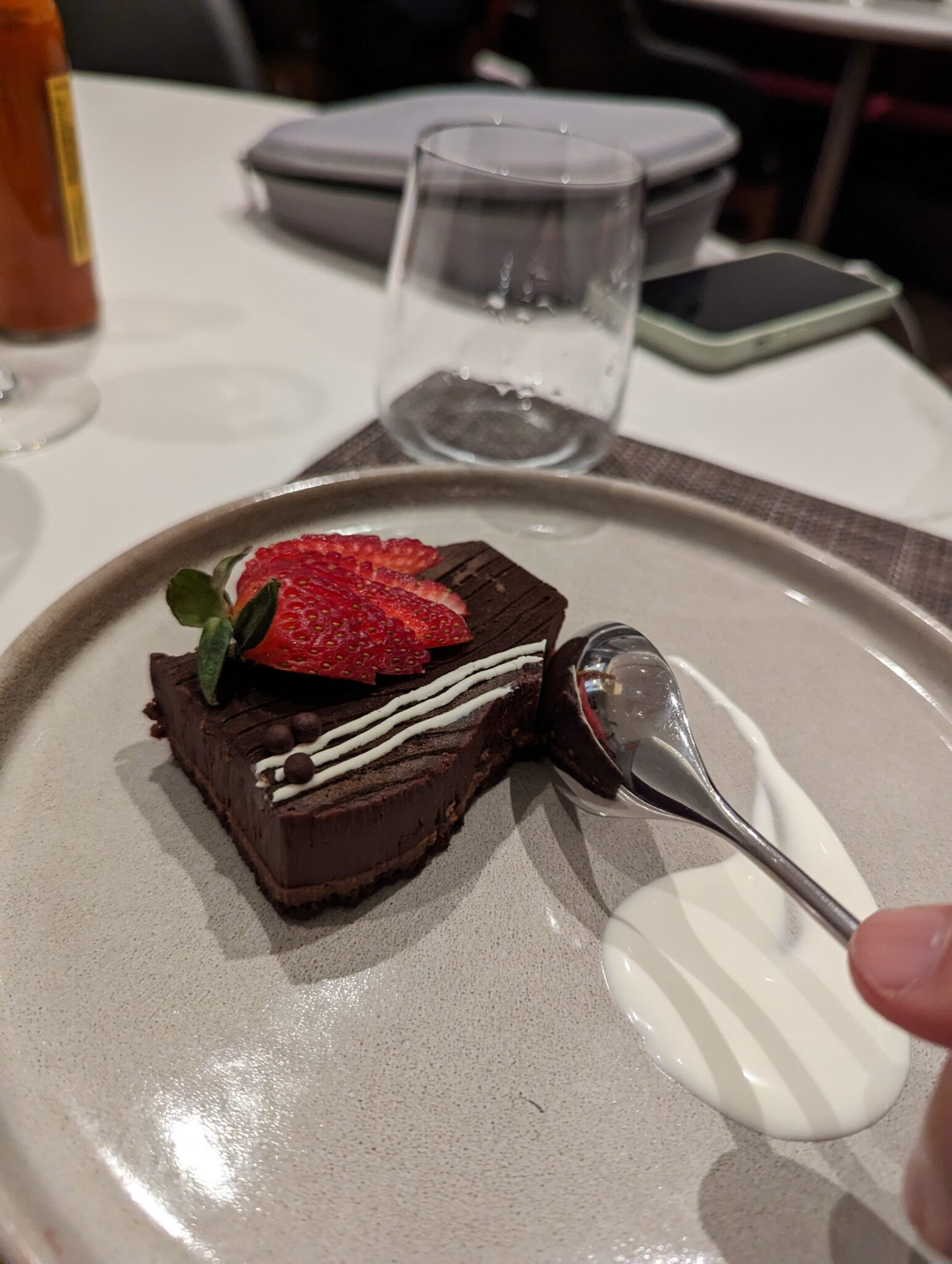a piece of chocolate cake with a spoon on a plate