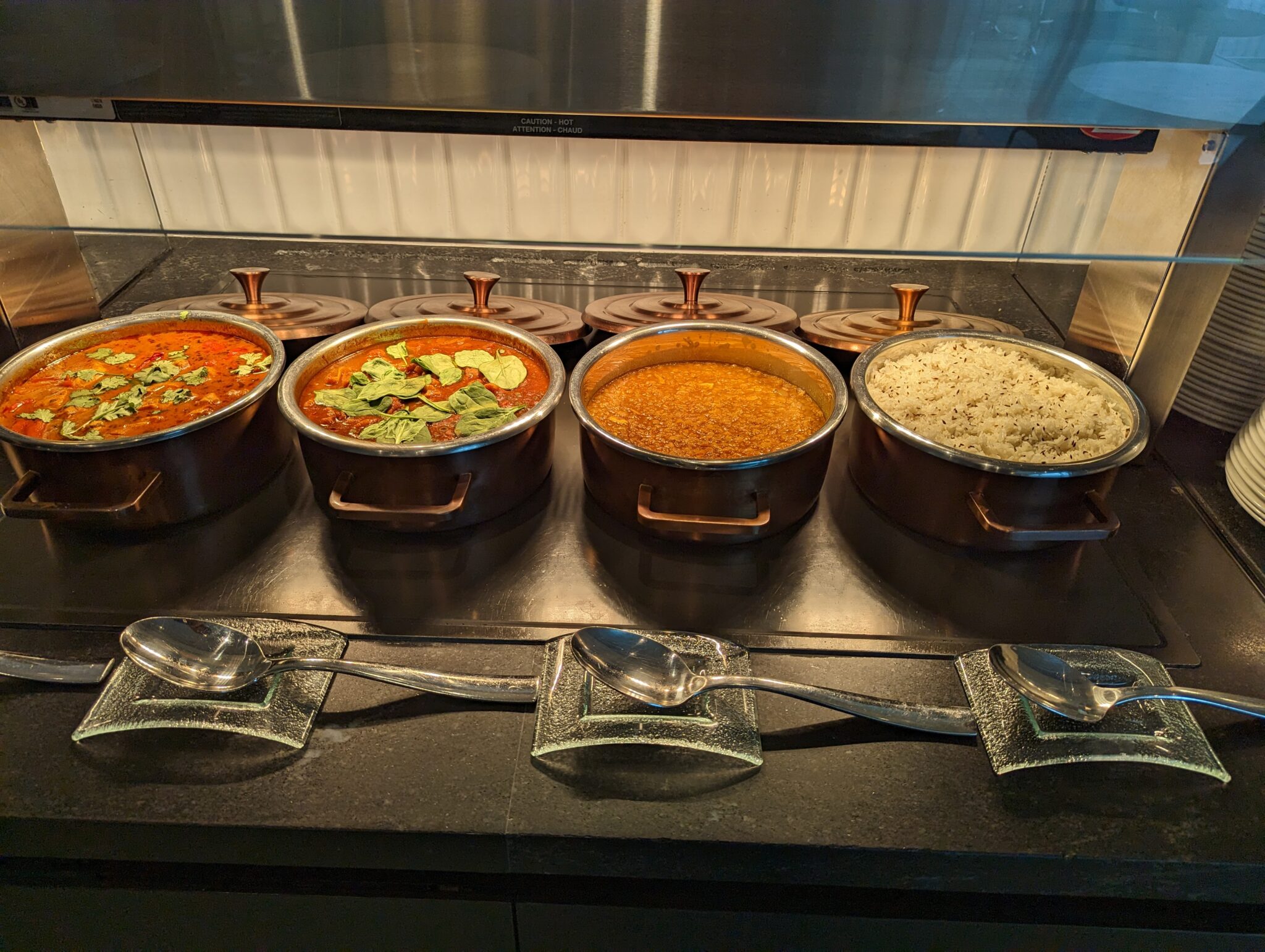 a group of pots of food on a counter