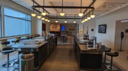 a bar with wine glasses and bottles