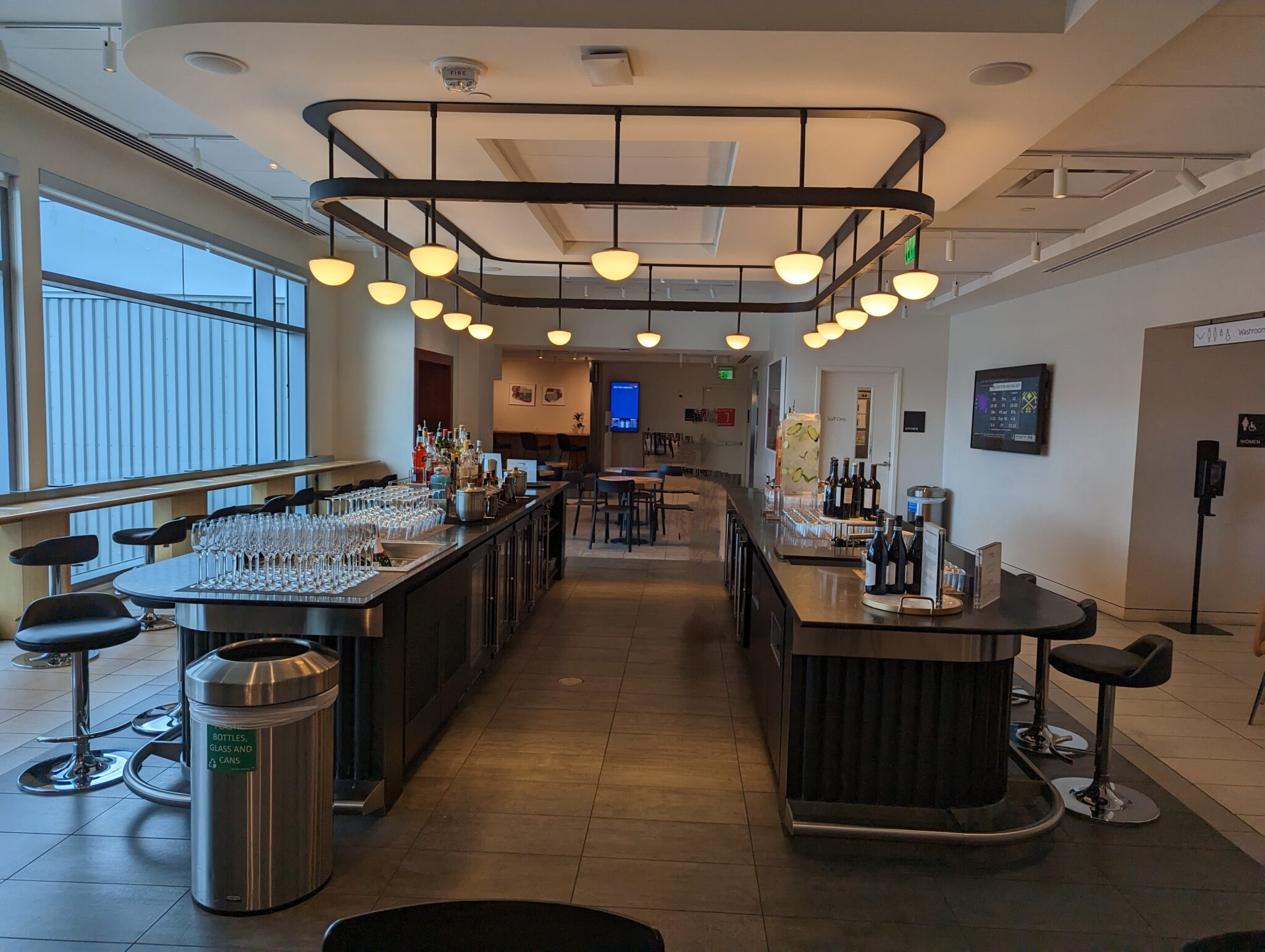 a bar with wine glasses and bottles