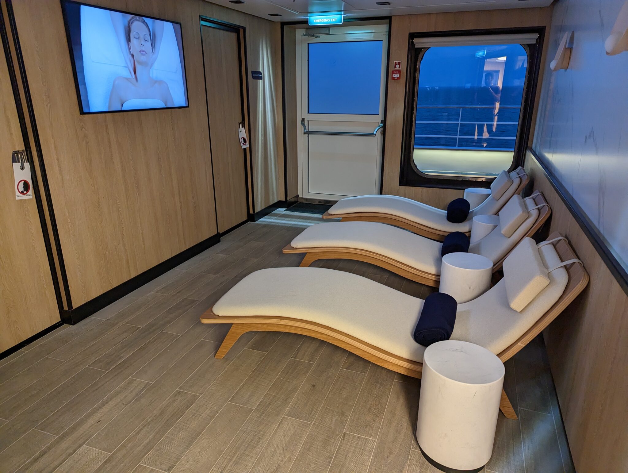 a room with chairs and a television on the wall