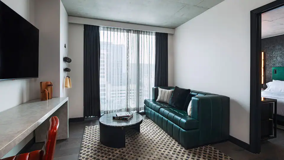 a living room with a green couch and a coffee table