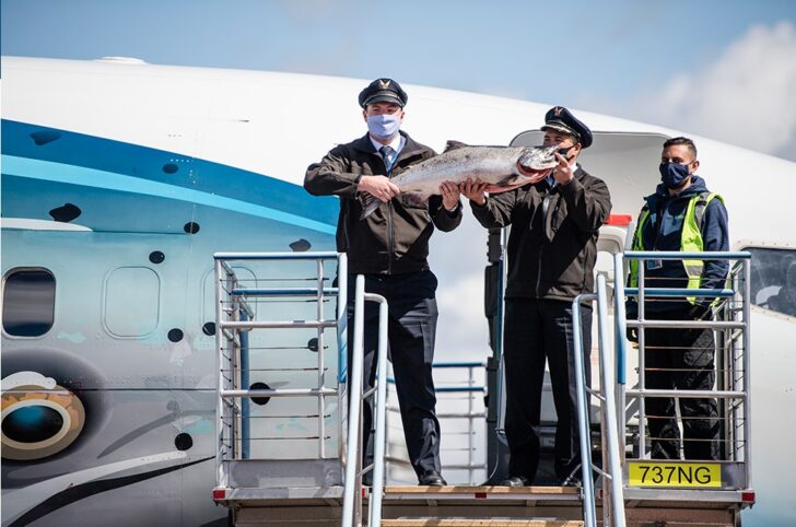 a group of people holding a fish