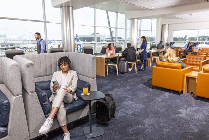 a woman sitting in a chair in a lounge area