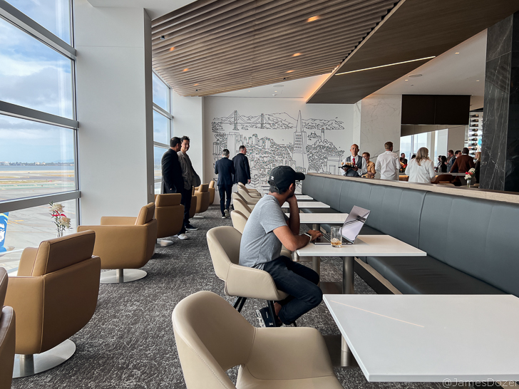 a group of people in a room with tables and chairs
