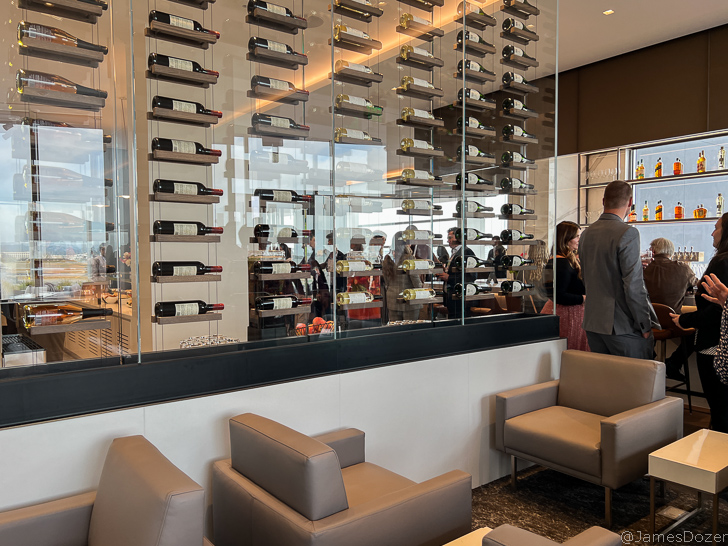 a glass wall with wine bottles on it