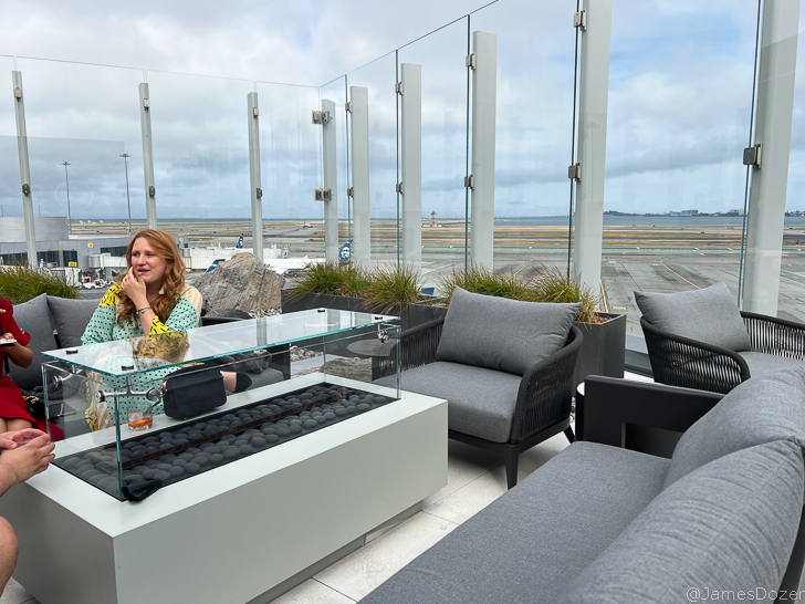 a woman sitting at a table with a glass top
