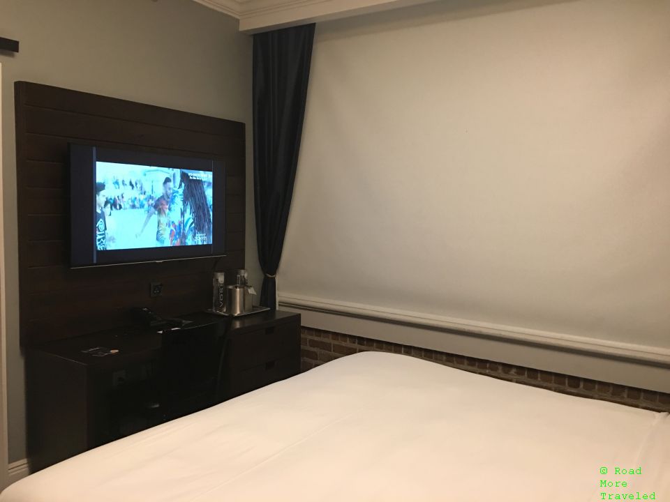 Q&C Hotel - one king bed guestroom TV and window