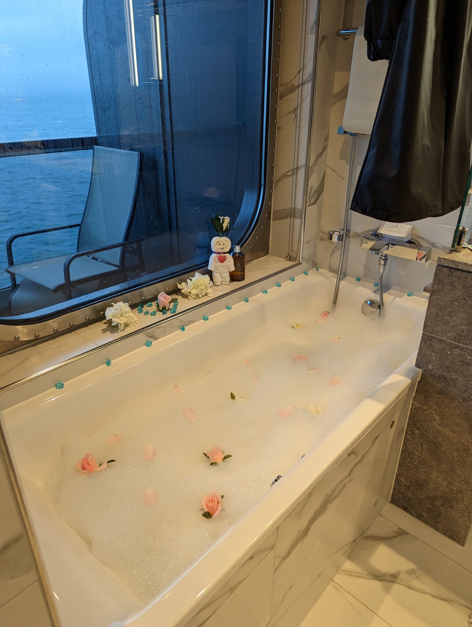 a bathtub with bubbles and flowers