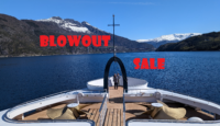 a boat on the water with mountains in the background