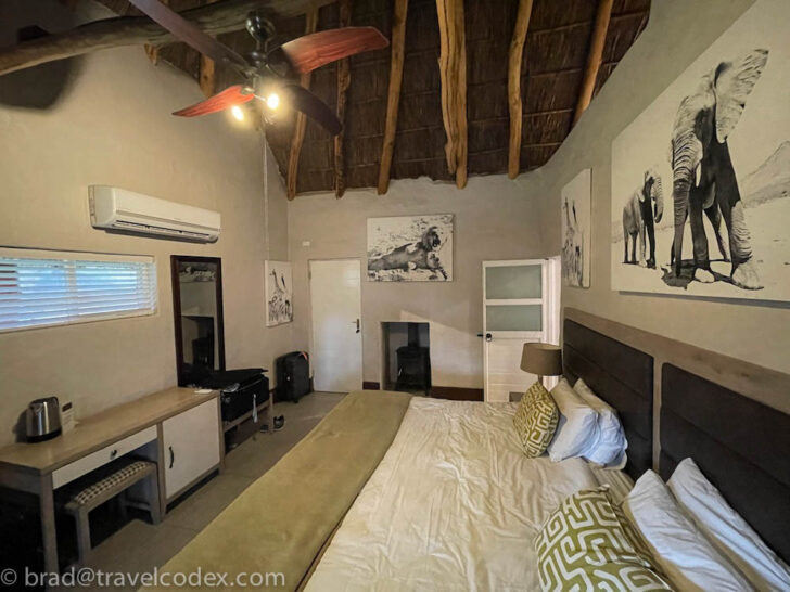 a room with a bed and pictures on the wall