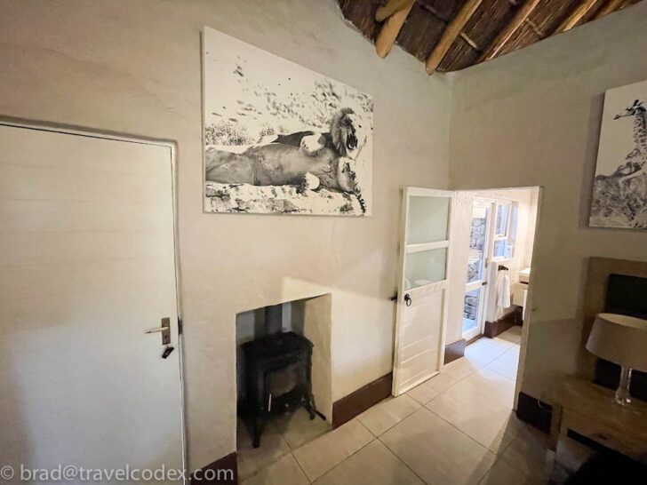 a room with a fireplace and a picture of a lion