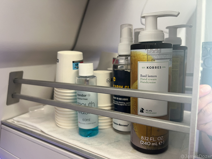 a shelf with bottles and cups
