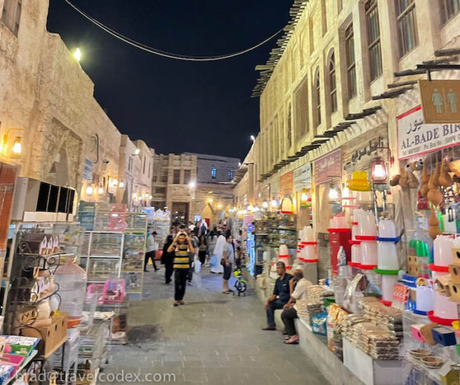 a street with many people and shops