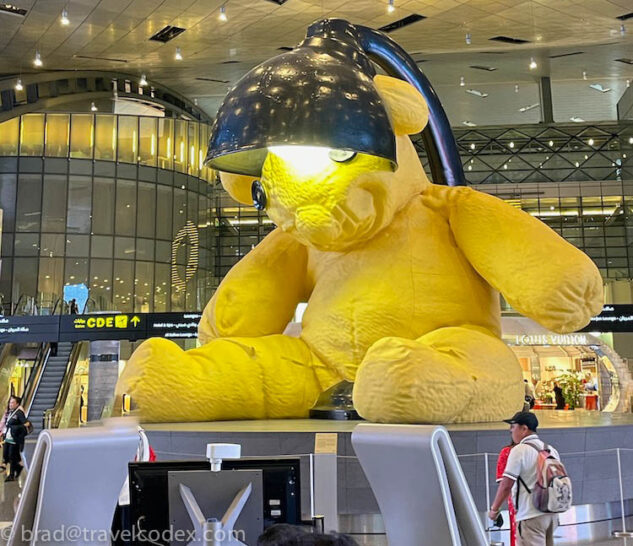 a large stuffed bear with a lamp on its head