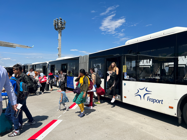 a group of people boarding a bus