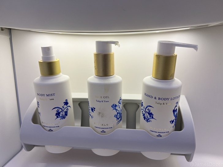 a group of white bottles with blue designs on them