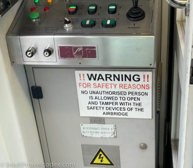 a control panel with buttons and a warning sign