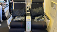 a seat with black pillows on the side