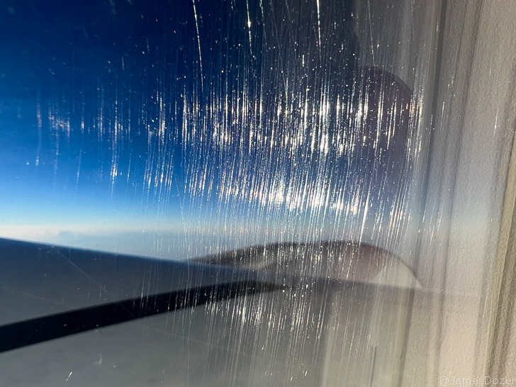 a window with a blue sky and clouds
