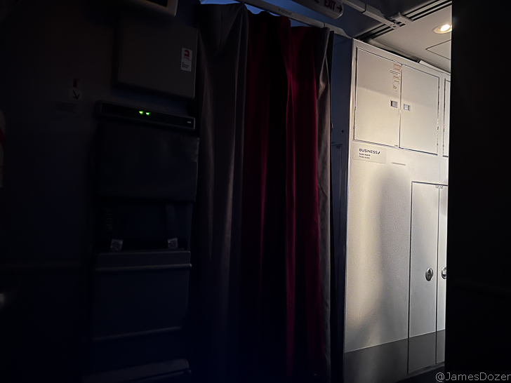 a room with a curtain and cabinets