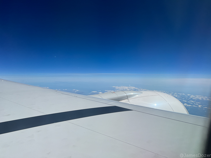 an airplane wing and blue sky