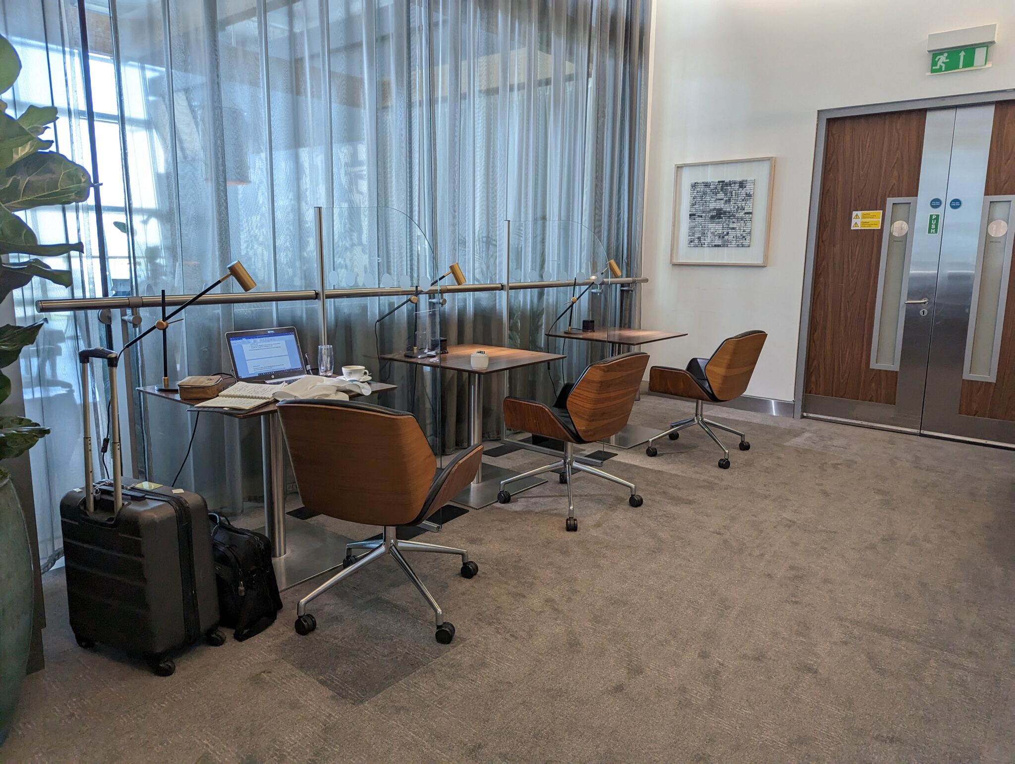 a room with a laptop and chairs