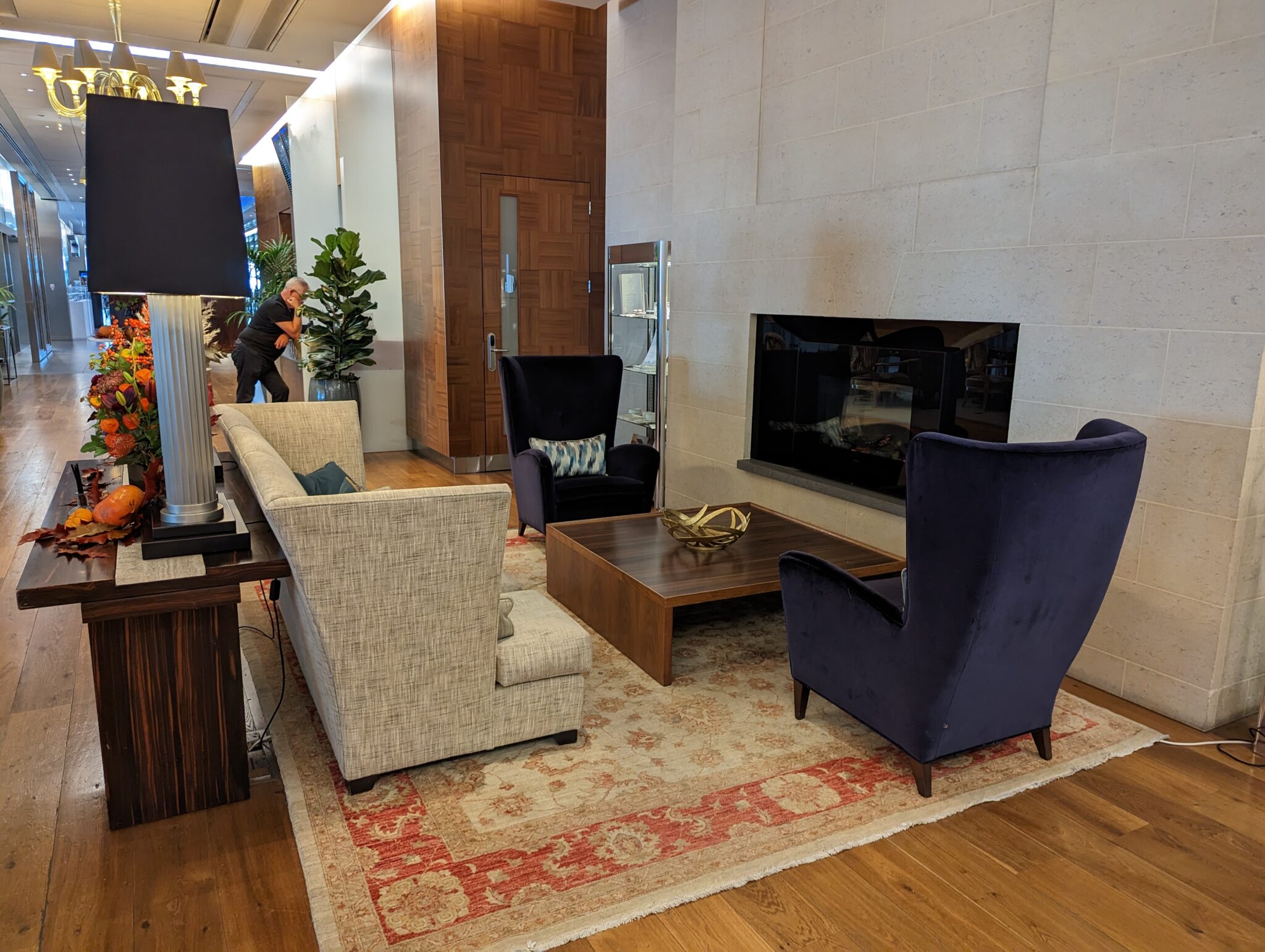 a room with a fireplace and chairs