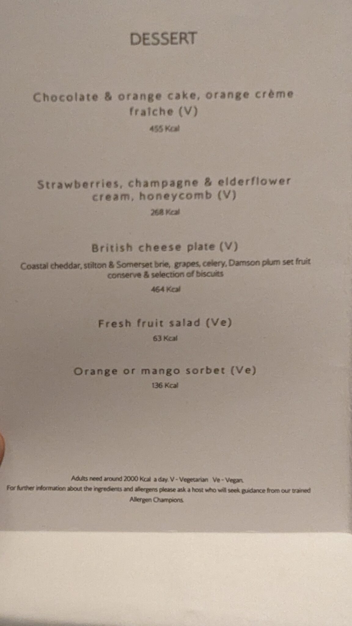 a hand holding a menu