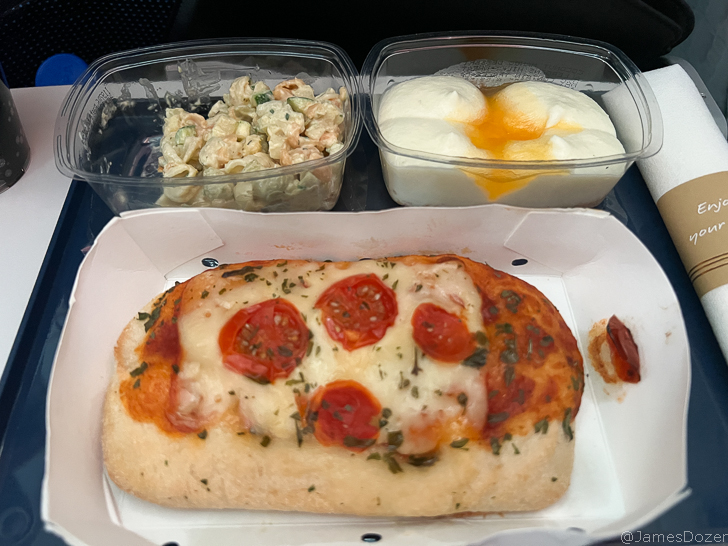 a plate of food with a slice of pizza and a side of salad