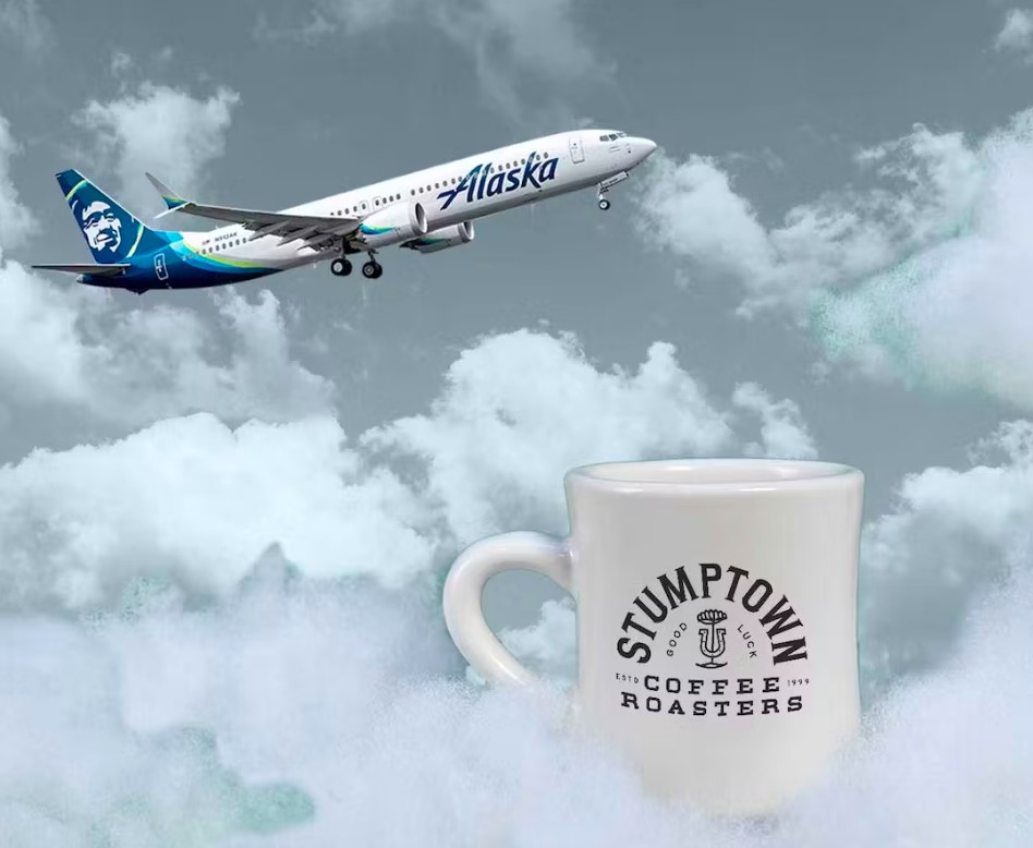 a white coffee mug with a plane flying in the air