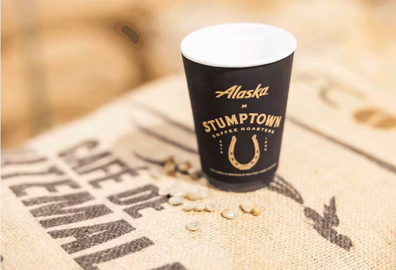 a cup of coffee on a burlap surface