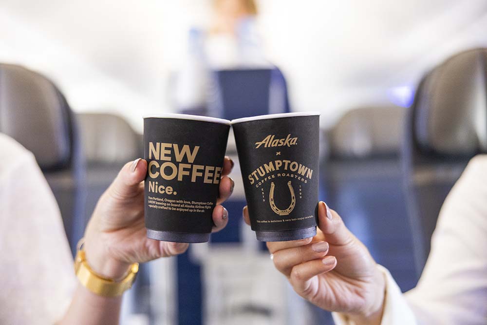 a pair of hands holding coffee cups