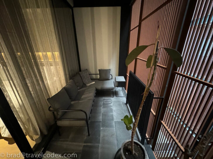 a room with a couch and a plant