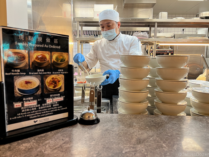 a man wearing a mask and gloves preparing food in a kitchen