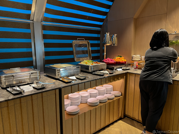 a woman standing in front of a buffet