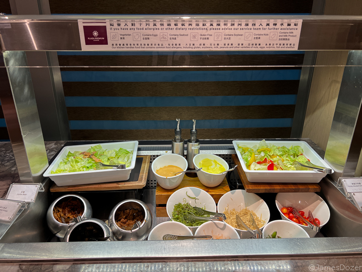a salad bar with bowls of food