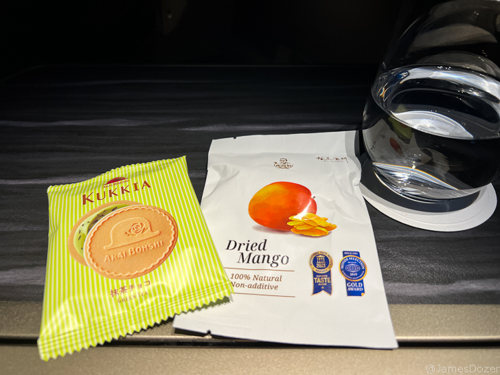 a glass of water next to a package of food
