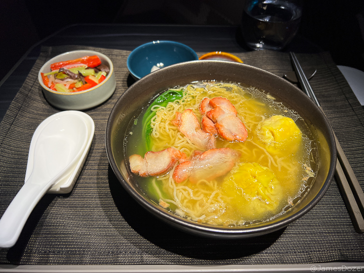 a bowl of soup with meat and noodles